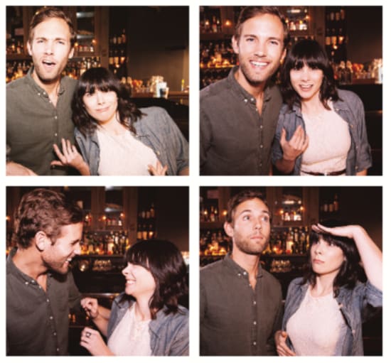 A couple posing for a photo booth picture.